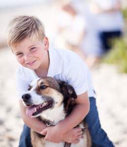 Handsome Young Boy Playing with His Dog