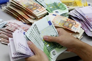 A bank employee counts Euro notes at Kasikornbank in Bangkok