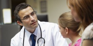Doctor examining young girl